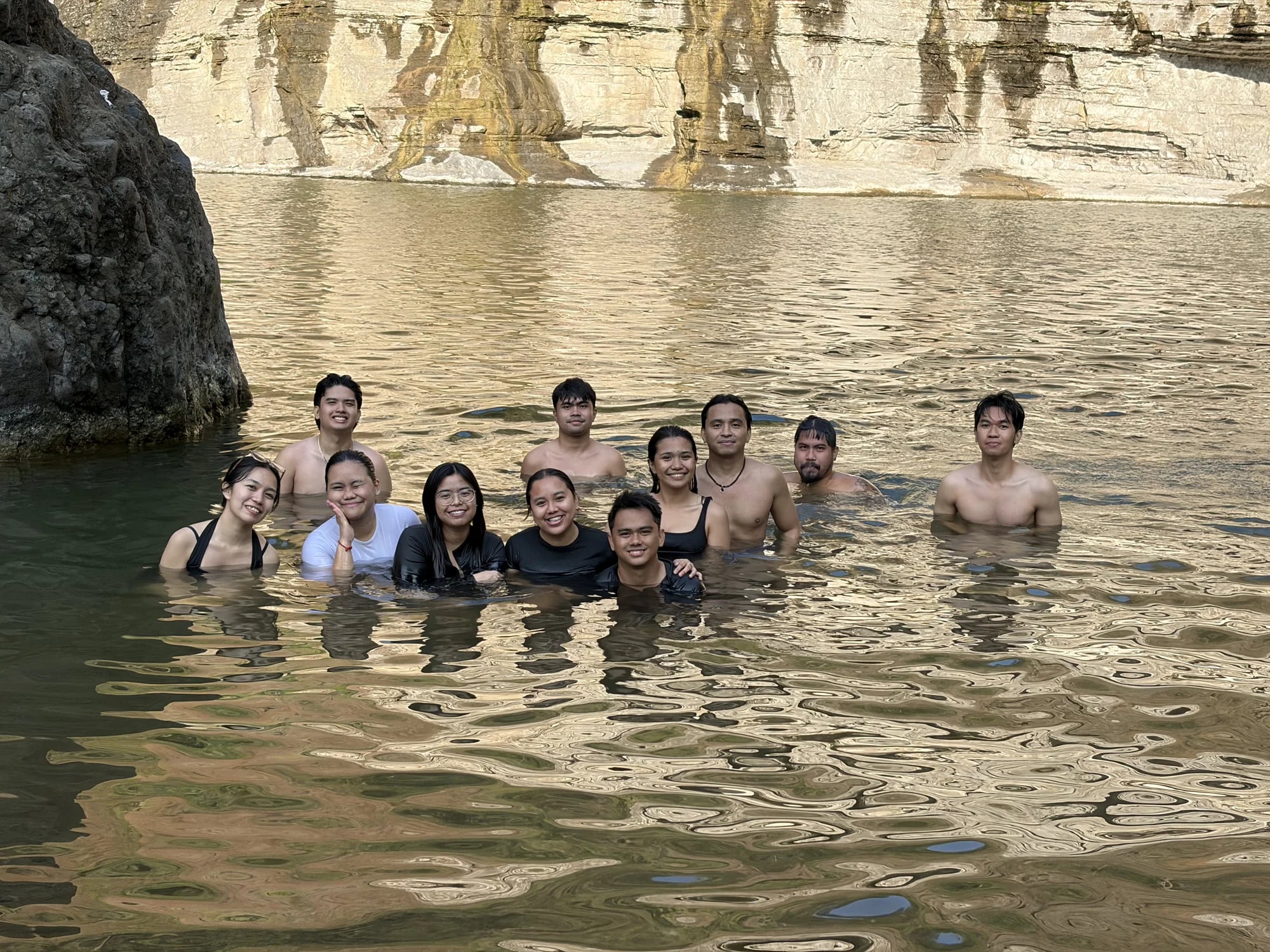 A group enjoying a swim in a natural rock pool